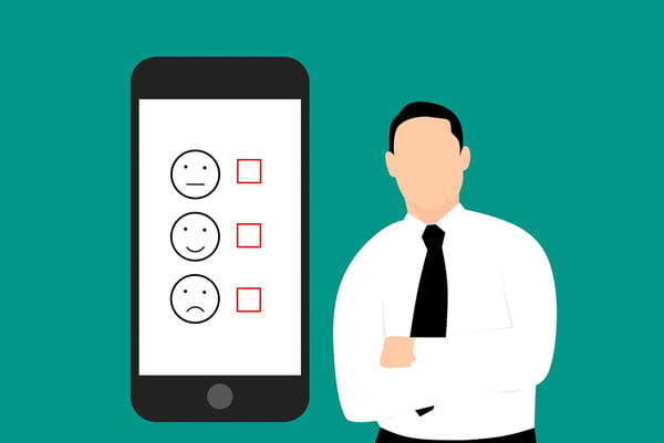 Person standing next to cell phone with feedback survey